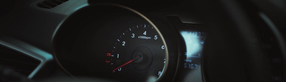 Interior of a car showing a detailed view of the speedometer and tachometer gauges.